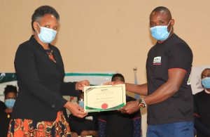 KIPPRA_Executive_Director_presents_certificate_to_a_student_at_the_KMPUs_event