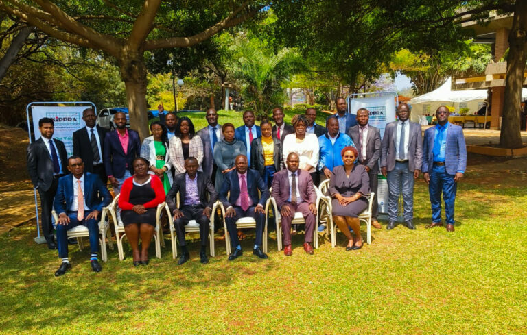 Stakeholders pose for a group photo at the meeting