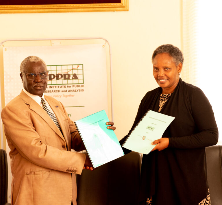KIPPRA Executive Director Dr Rose Ngugi (right) and Laikipia University Vice Chancellor (left) pose for a group photo after signing MOU