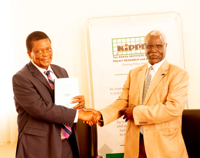 KIPPRA Board Chair Prof. Benson Ateng’ (left) with the Vice Chancellor Laikipia Prof. Joseph K Rotich University (right) pose for a group photo after the signing of the MOU at KMPUT Event