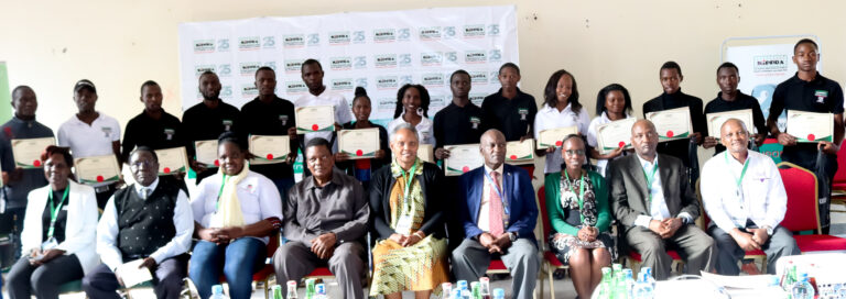 KIPPRA Executive Director ( center) Board Chair (left) ,Machakos University Faculty Members and  Students pose for a group photo after receiving their certificates at the KMPUs event